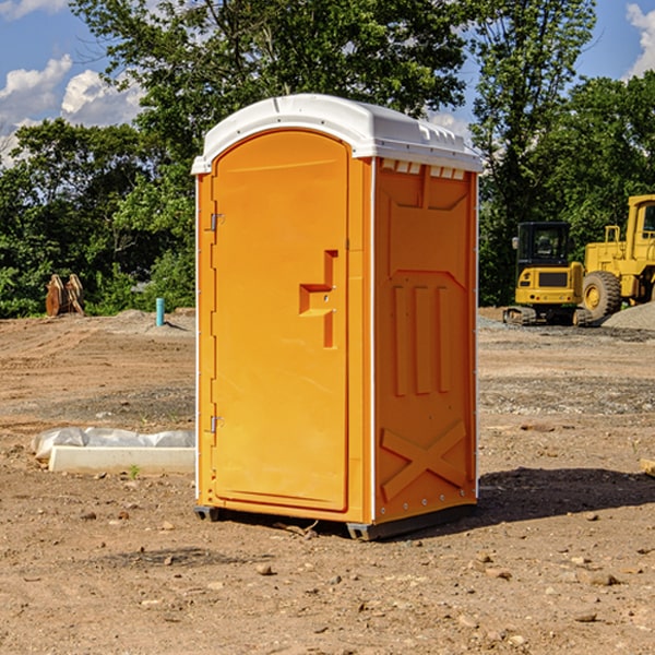 what is the cost difference between standard and deluxe portable restroom rentals in Milan